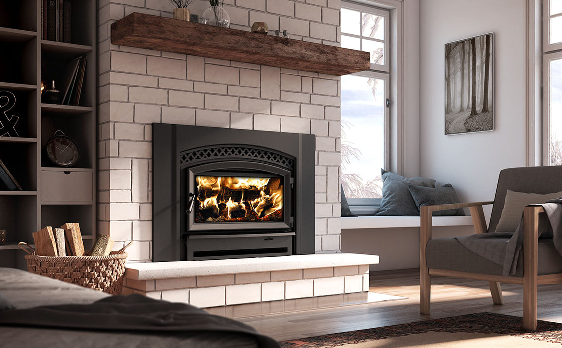 Enerzone Destination 2.7 wood insert with a fire burning, installed in a whitewashed brick fireplace with a reclaimed timber mantel and window seat