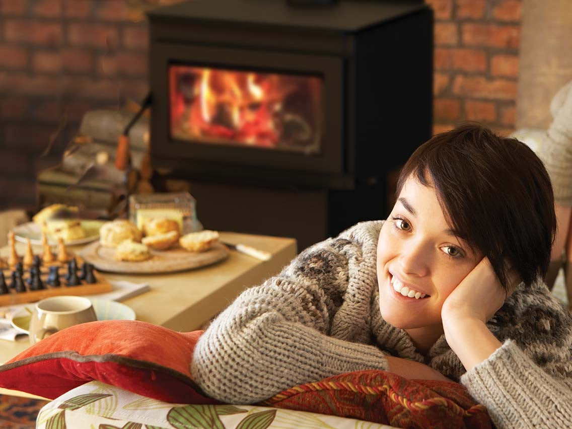 Relaxing by a wood stove with a fire burning