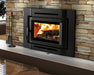 Enerzone Destination 2.3-I wood insert with a fire burning, shown wide in a stone fireplace with its contemporary flush cast iron surround and fireplace tools alongside